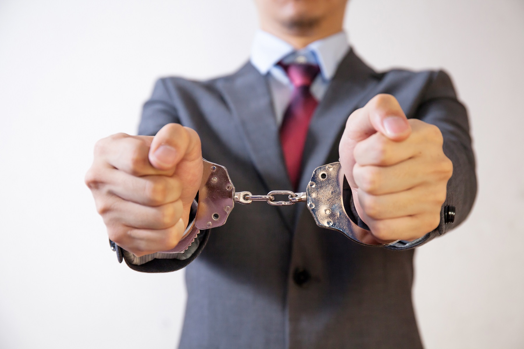 business man criminal handcuffed 2022 01 28 06 51 48 utc